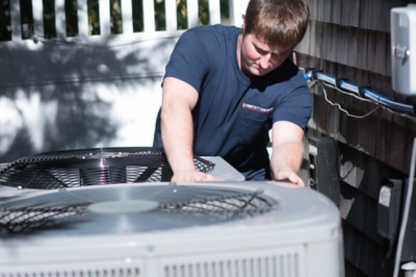 Fawcett Energy HVAC technician tending to air conditioner units