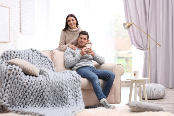 Happy couple spending time together at home while keeping warm