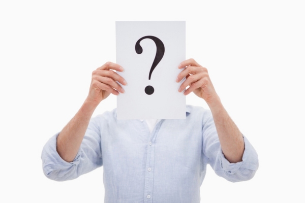 man holding paper with question mark covering his face depicting What Temperature to Set Air Conditioner in Summer FAQs