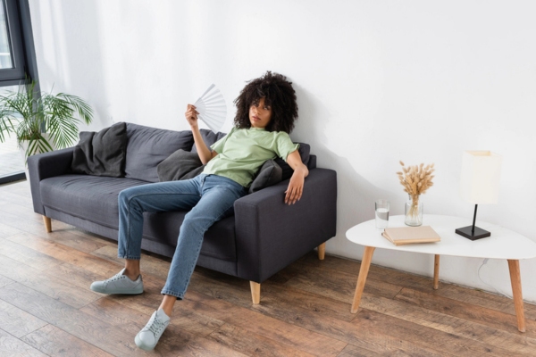 woman feeling warm with AC not blowing cool air indoors