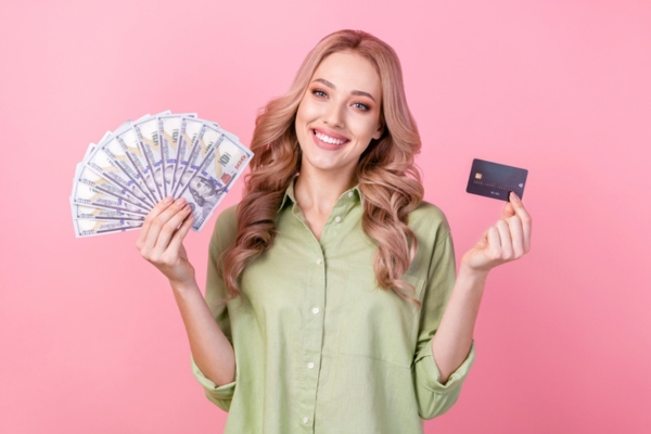 woman holding cash and card on each hand depicting heating oil payment options